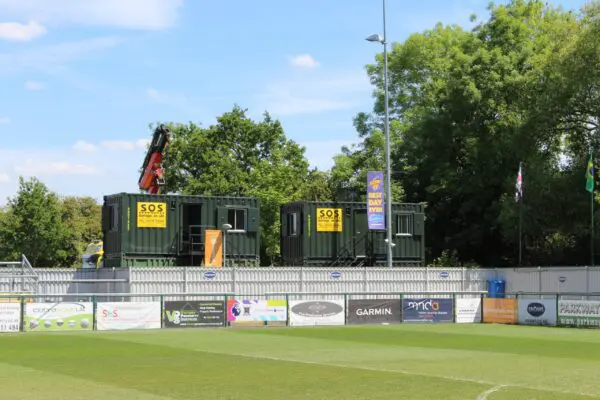 Stacked 20ft site cabins overlooking AFC Totton football pitch