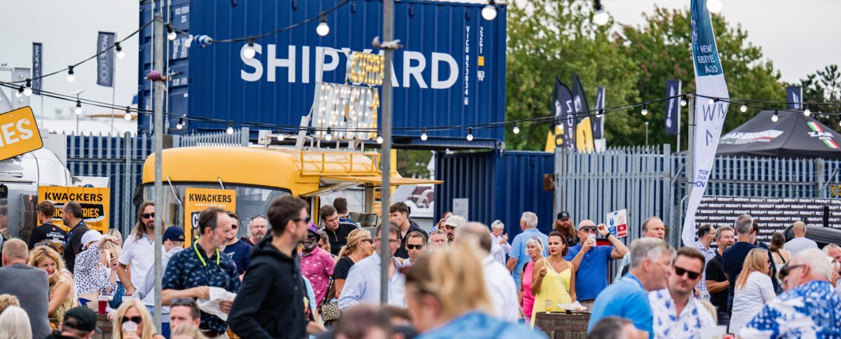 People enjoying street food and music at Southampton Boat Show 2023 Shipyard area.