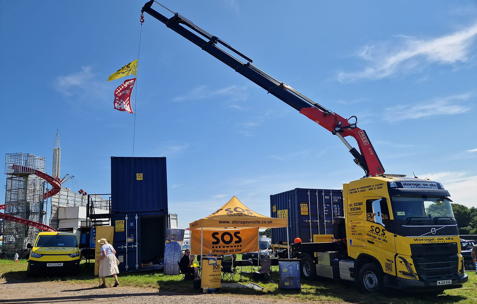 Wide shot of the Storage on Site event stand at the Netley Marsh Steam Rally, featuring a new crane-assisted truck, shipping containers, and the stand.