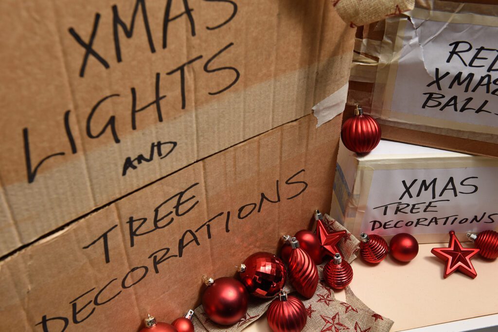 Close-up of cardboard boxes filled with Christmas decorations stored in a shipping container.